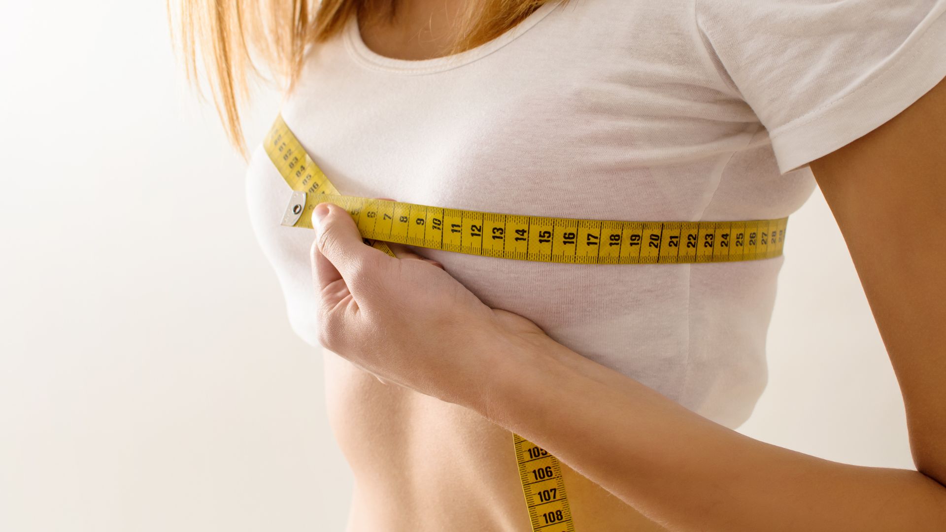woman measuring breast