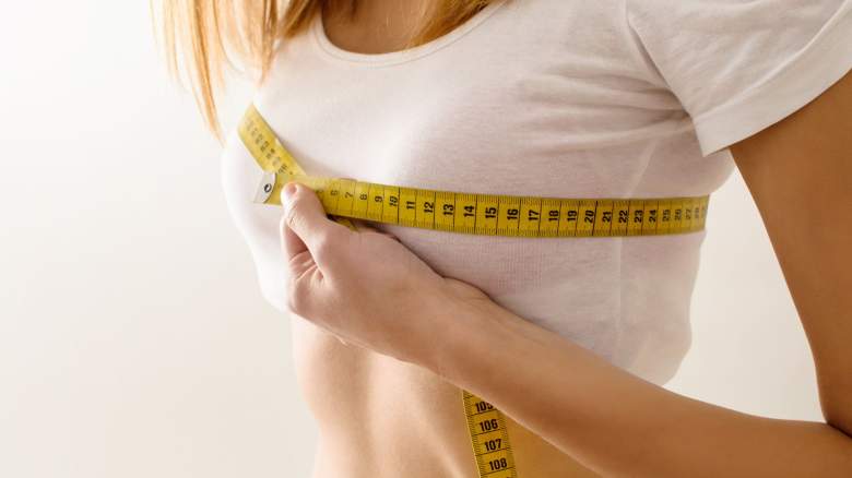 woman measuring breast