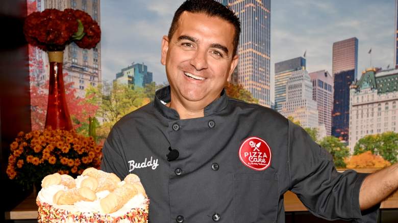 Buddy Valastro smiling and holding a cake