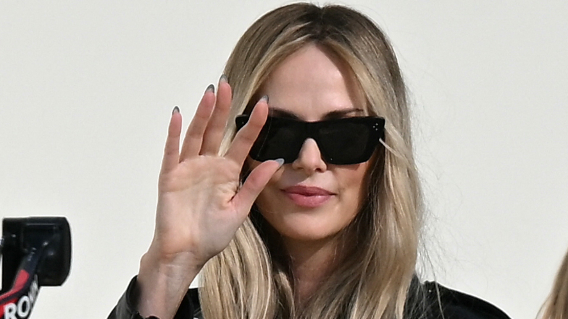 Charlize Theron waving