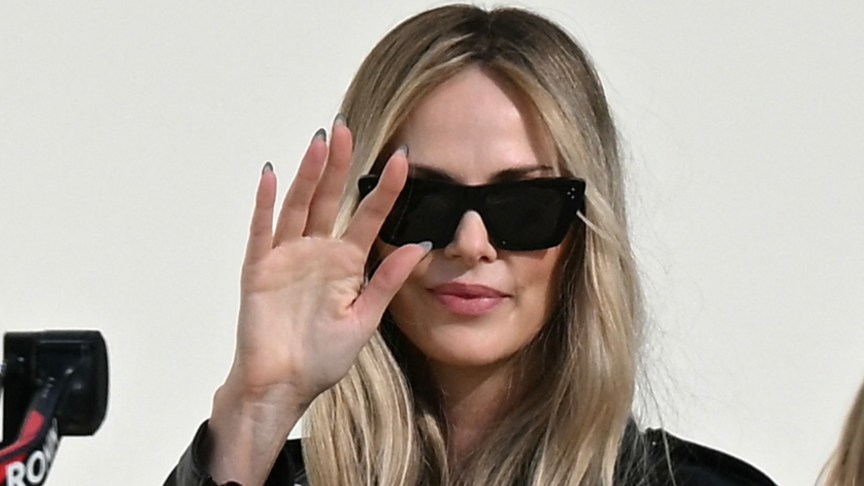 Charlize Theron waving
