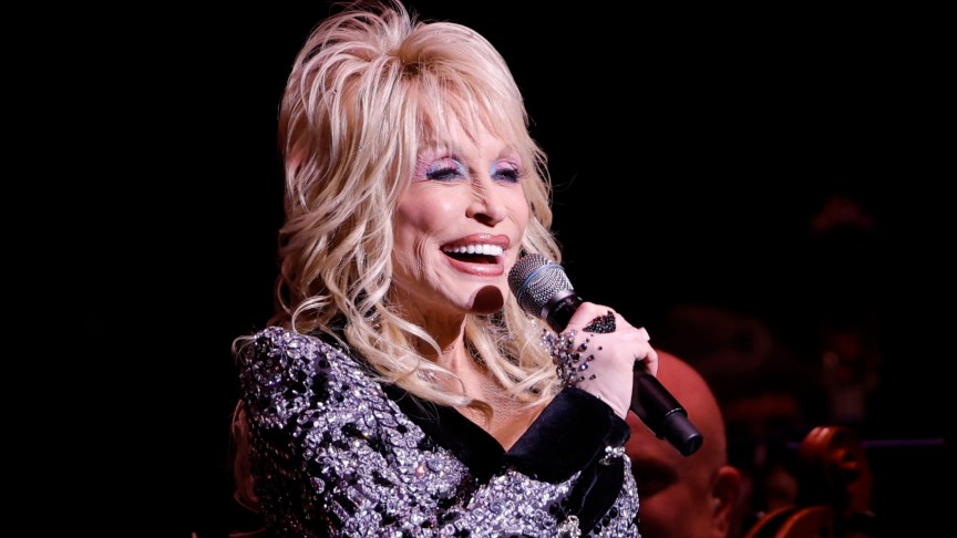 Dolly Parton performing with a microphone