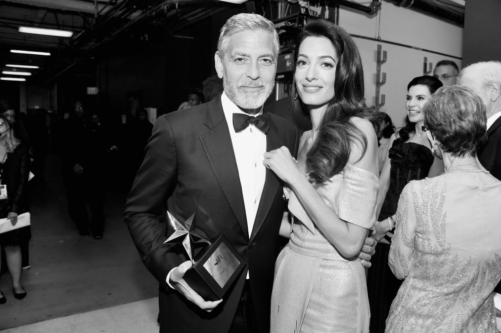 George Clooney (L) and Amal Clooney