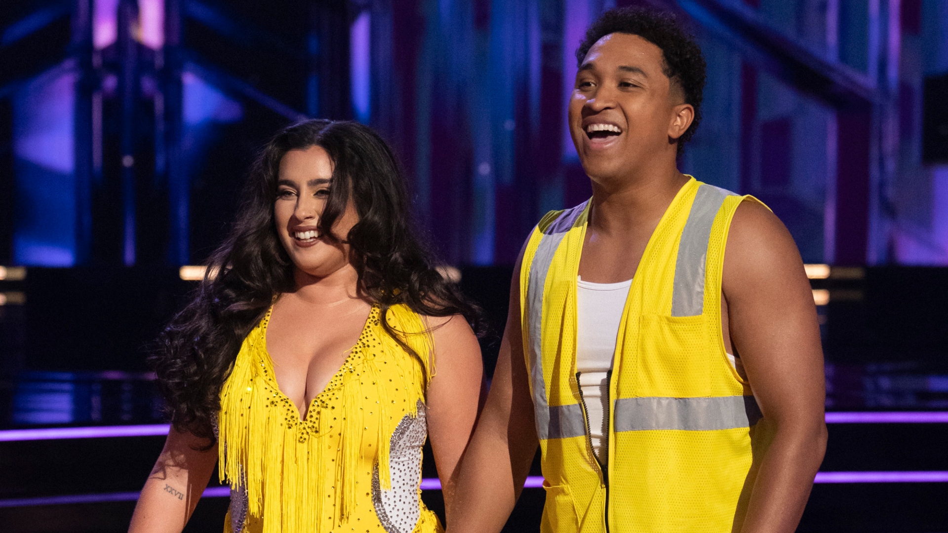 Lauren Jauregui and Brandon Armstrong smiling onstage