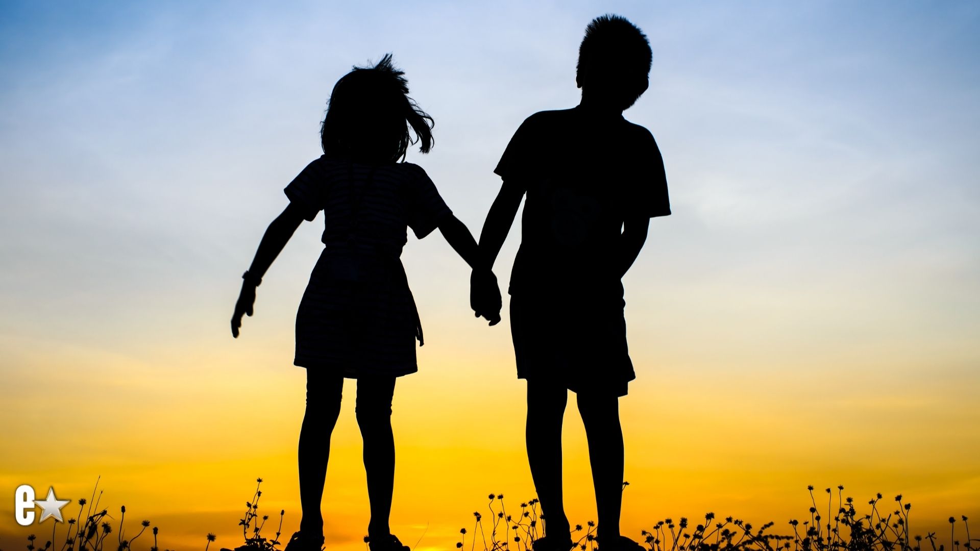 Brother and sister holding hands