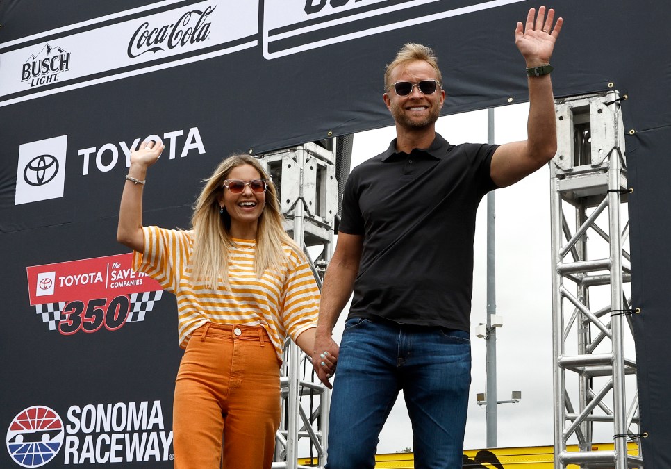 Candace Cameron Bure and husband Valeri Bure waving