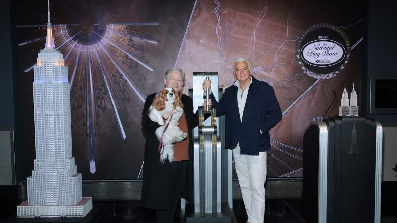 L-R) David Frei, holding "TruDat" and John O'Hurley pose as they light the Empire State Building in honor of the National Dog Show at The Empire State Building
