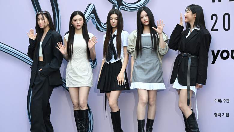 K-pop girl group NewJeans members pose on the blue carpet at the 2025 Spring/Summer Seoul Fashion Week