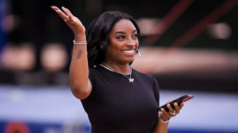 Simone Biles smiling and waving