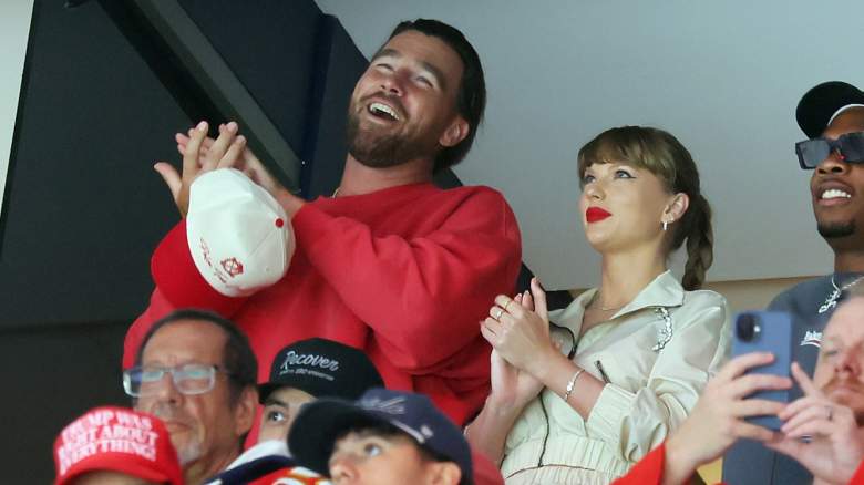 Taylor Swift and Travis Kelce smiling and clapping