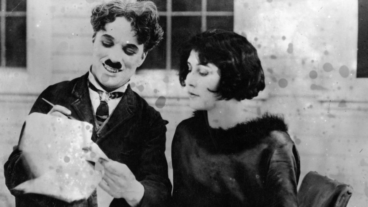 Charlie Chaplin (Sir Charles Spencer Chaplin, 1889 - 1977), English film actor and director signs up his second wife Lita Grey