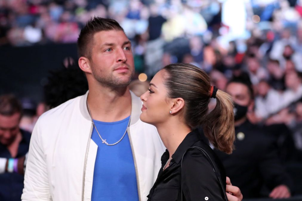 Tim Tebow and wife Demi-Leigh Nel-Peters are seen by the octagon during UFC