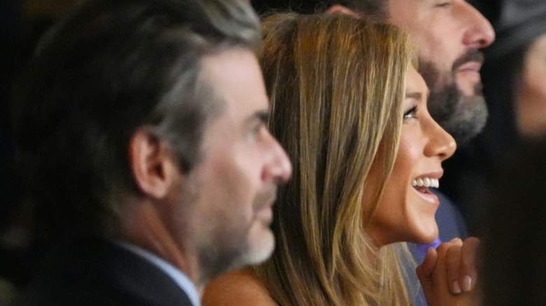 Jim Curtis and smiling Jennifer Aniston attend an event