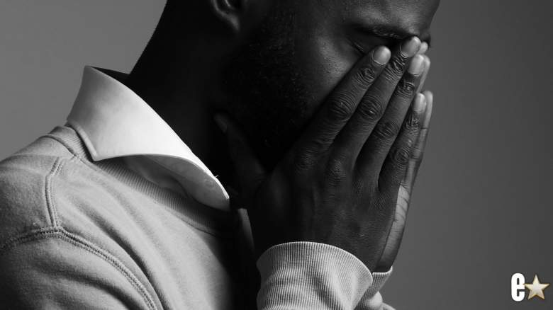 Man holding his hands over his eyes