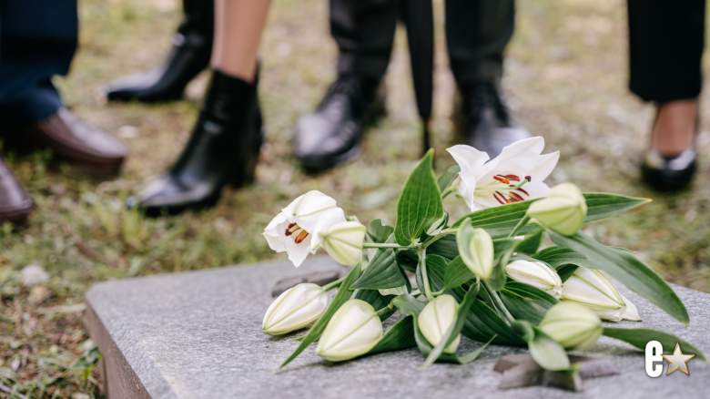 white flowers on top of a grave stone