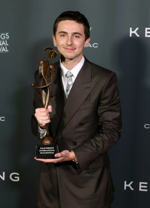 Timothée Chalamet holding a trophy at 37th Annual Palm Springs International Film Festival Film Awards