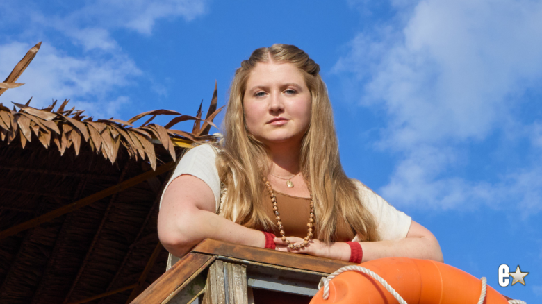 Jaicy Elliot standing on boat with arms folded