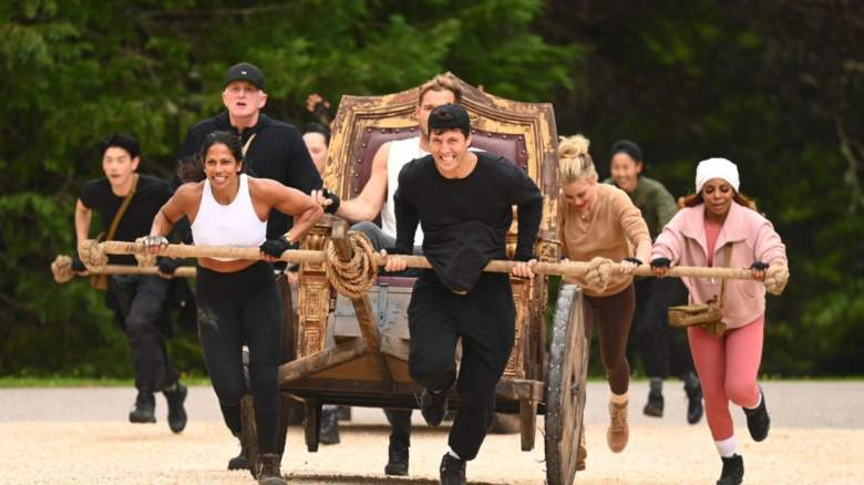 THE TRAITORS -- "The Death Conga" Episode 402 -- Pictured: (l-r) Eric Nam, Natalie Anderson, Michael Rapaport, Colton Underwood, Rob Rausch, Tara Lipinski, Candiace Dillard Bassett -- (Photo by: Euan Cherry/Peacock)