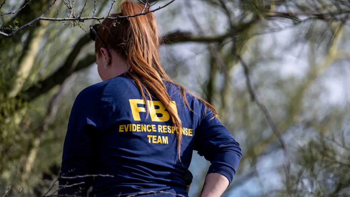 FBI investigator searching for evidence around Nancy Guthrie's home
