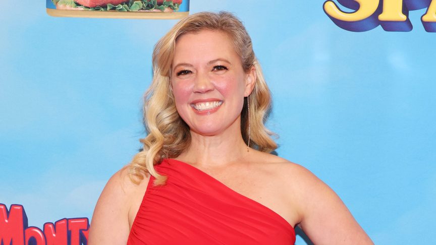 Patti Murin grins in red one-strap gown