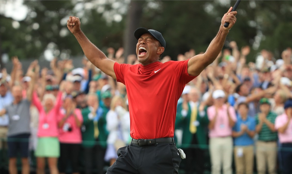 Tiger Woods (L) of the United States celebrates on the 18th green after winning the Masters at Augusta National Golf Club on April 14, 2019