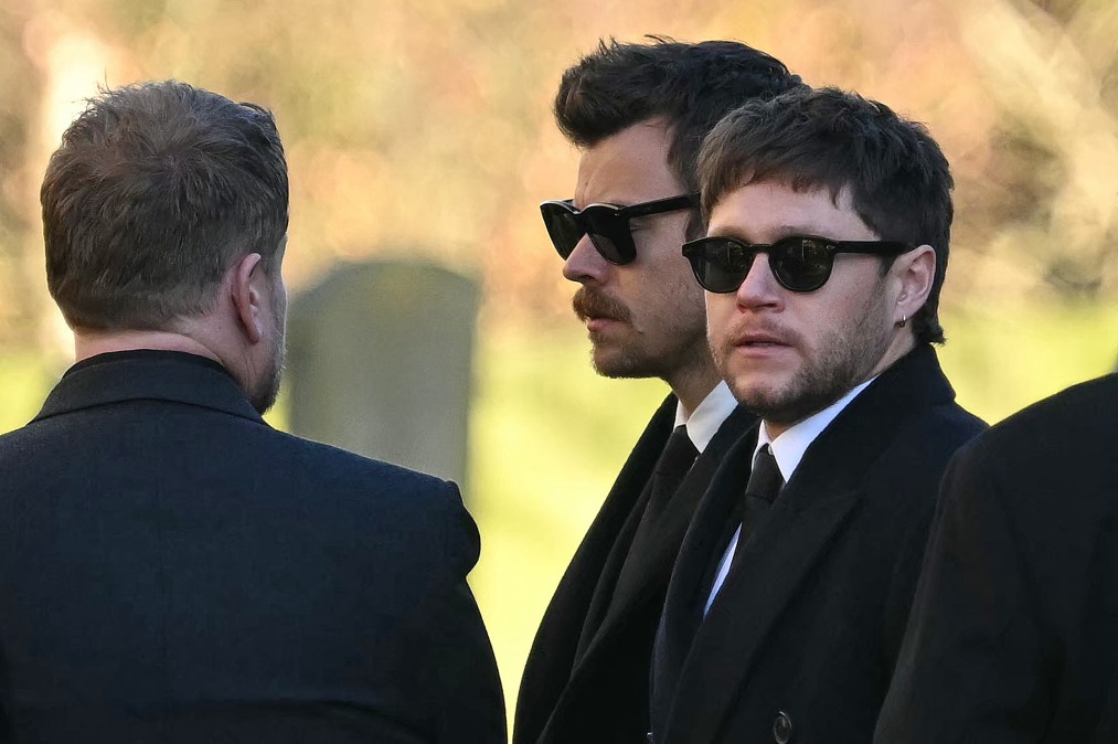 Former One Direction band members Harry Styles (C) and Niall Horan leave after attending the funeral service of the late One Direction singer Liam Payne