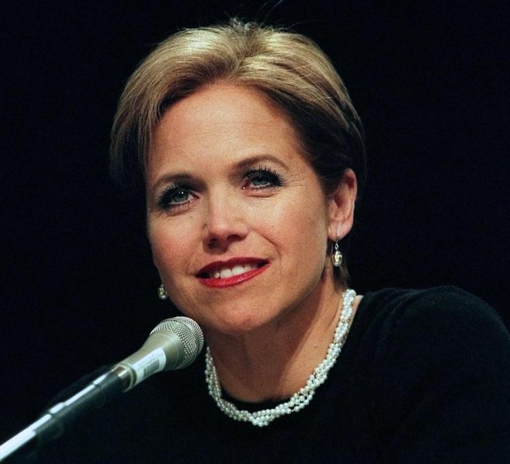 Katie Couric speaking into a microphone