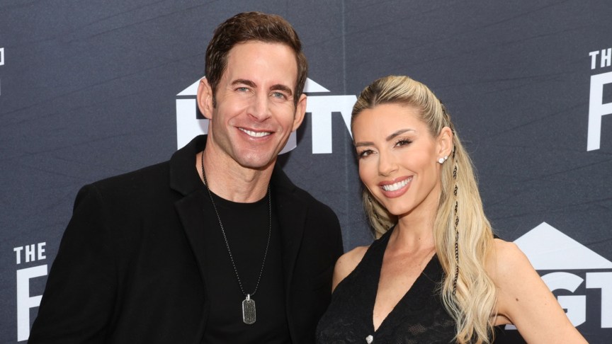 Tarek El Moussa and Heather Rae El Moussa smile at an event