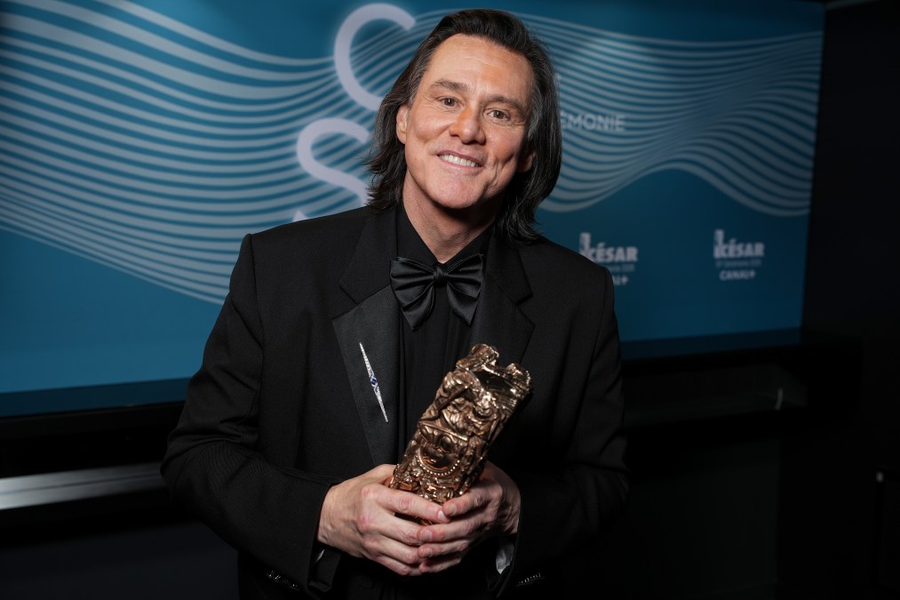 Jim Carrey poses with the Honorary Cesar Award backstage during the 51st Cesar Film Awards.