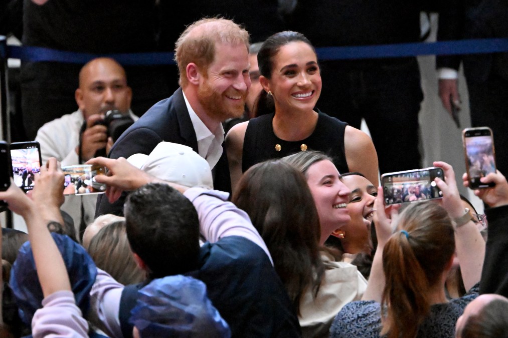 Britain's Prince Harry (L), Duke of Sussex, and his wife Meghan (R),