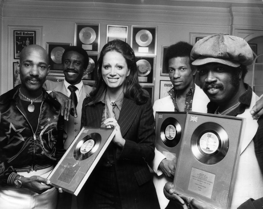 Tony Wilson (second from right) with Hot Chocolate and author Jackie Collins.