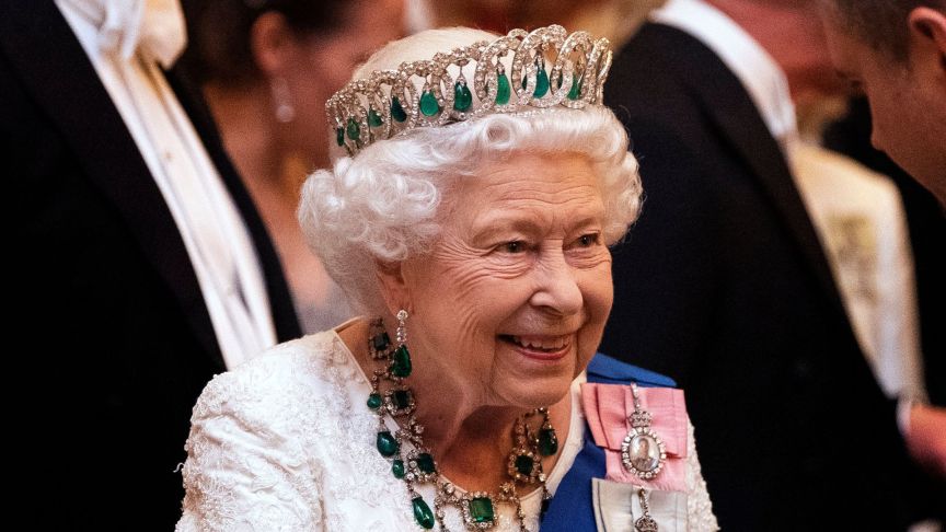 Queen Elizabeth II talks to guests at an evening reception for members of the Diplomatic Corps at Buckingham Palace on December 11, 2019
