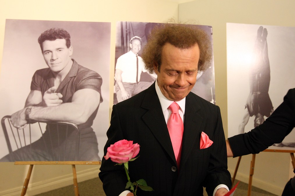 Richard Simmons is seen near photos of the first television fitness guru, Jack LaLanne, before the start of the funeral service for Jack LaLanne.