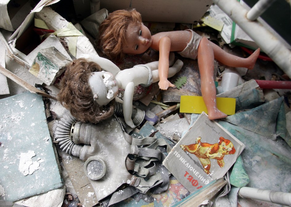 Dolls and a gas mask are left behind in a kindergarten in the ghost town of Pripyat near Chernobyl's nuclear power plant 27 February, 2006. 