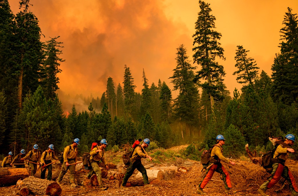 TOPSHOT - A crew of Plumas Hotshots walk from a fire line during the Park fire in Tehama County's Mill Creek area of California August 7, 2024.