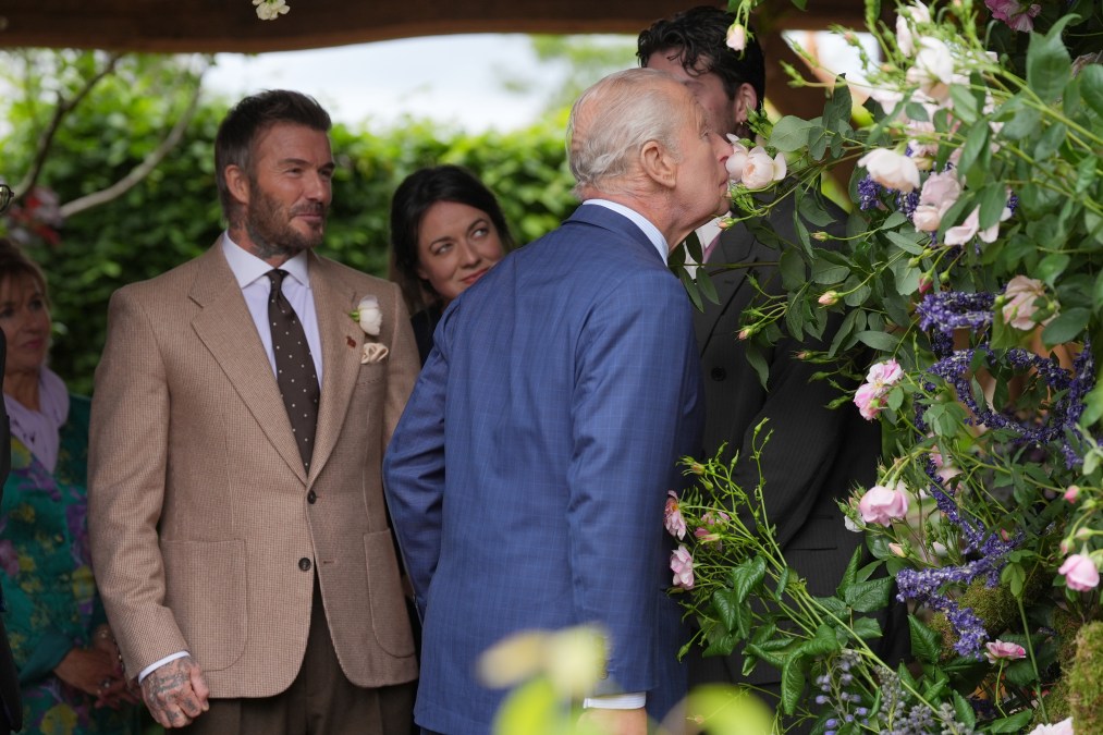 King Charles III smells a rose named after David Beckham.