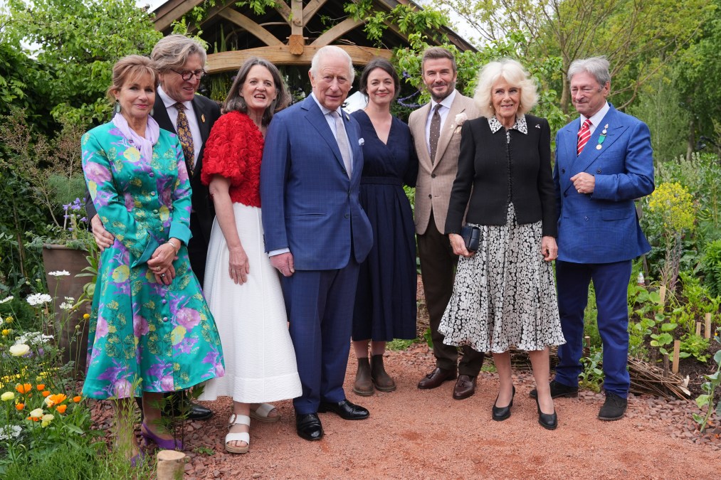 King Charles III, David Beckham, Queen Camilla, and Alan Titchmarsh pose with other guests.
