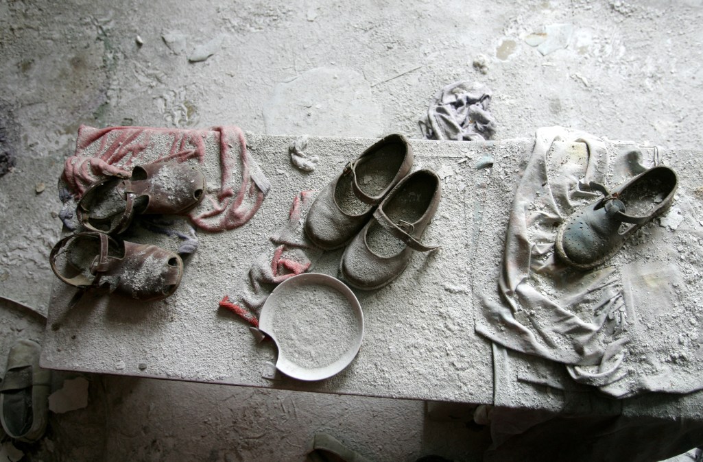 TOPSHOT - Children' shoes remain in a kindergarten in the ghost town of Pripyat near Chernobyl's nuclear power plant 27 February, 2006.
