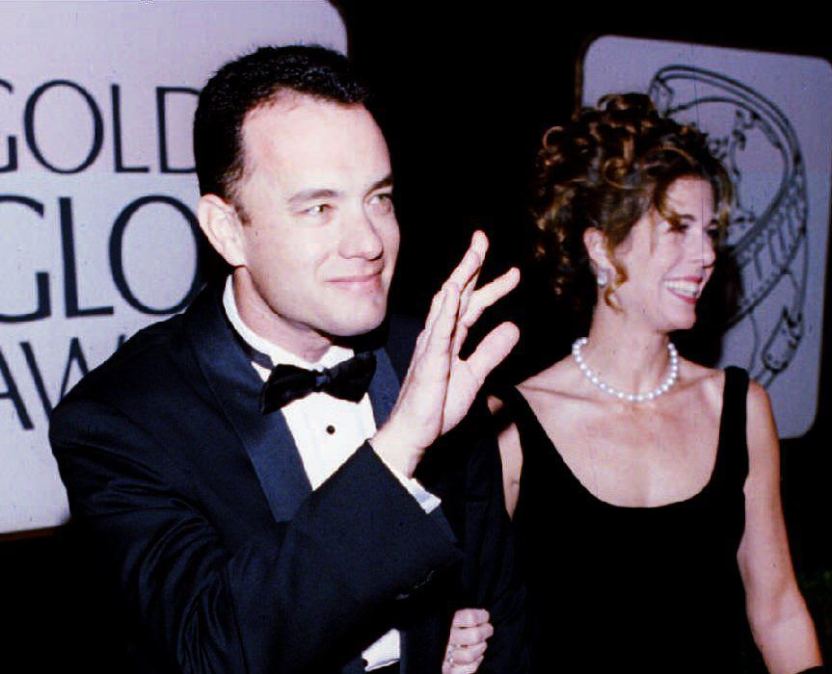 US actor Tom Hanks (L), with his wife, Rita, waves to photographers as they arrive for the 51st Golden Globe Awards 