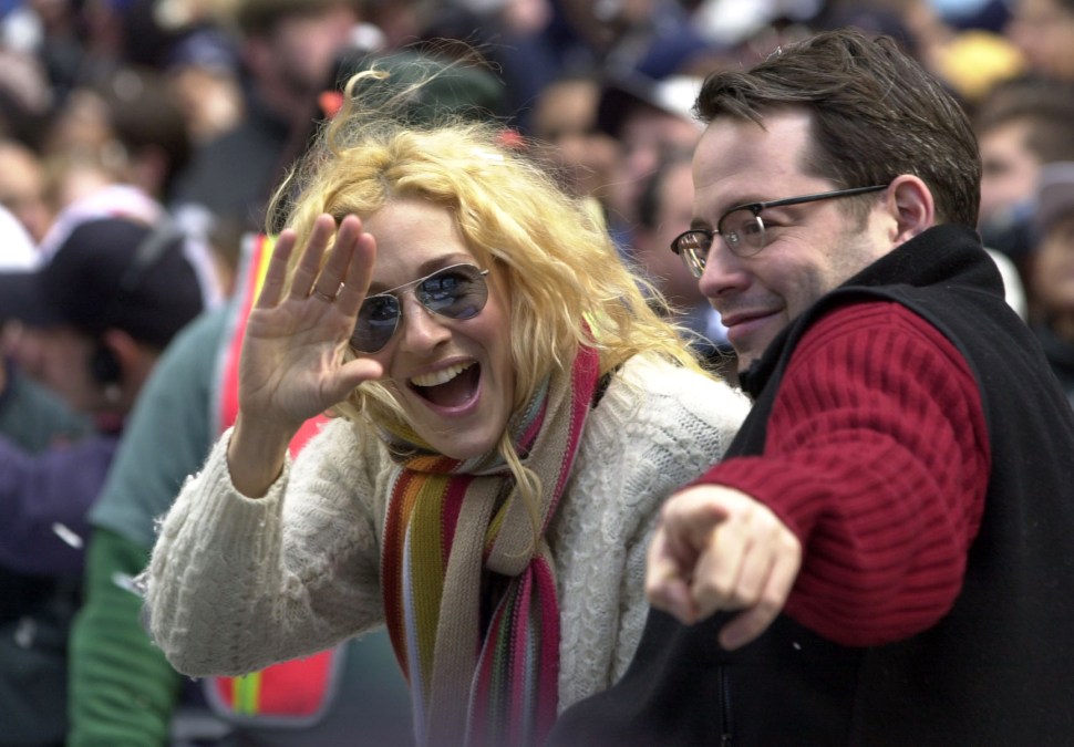New York Yankee fans Sarah Jessica Parker and Matthew Broderick wave to the crowd during the Yankees victory parade up the Canyon of Heroes in New York City.