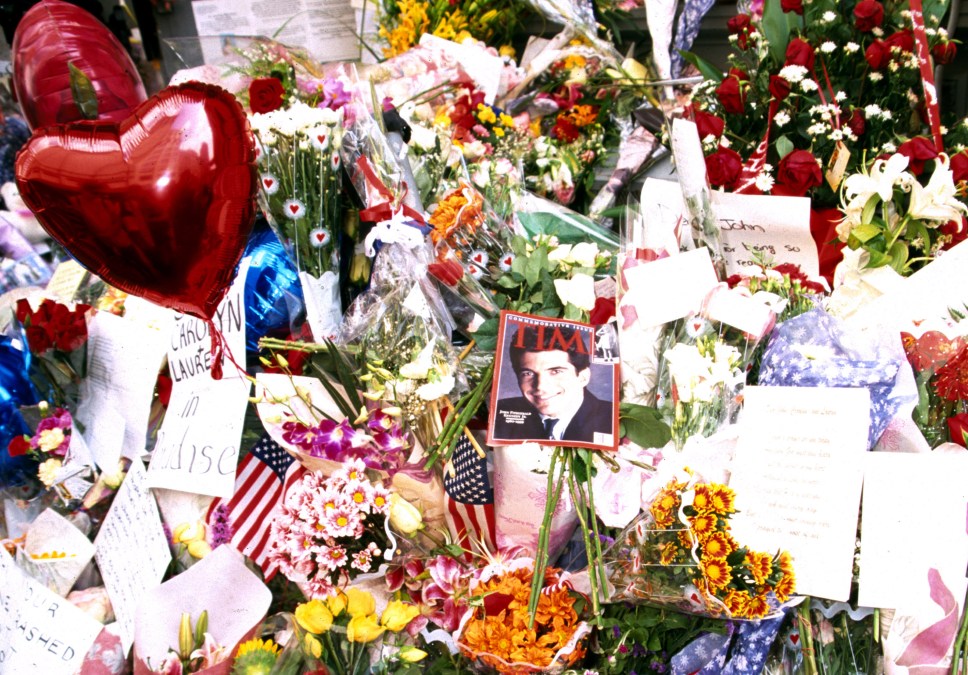 A memorial of flowers, cards and American flags are left outside, July 20, 1999, in front of the residence of John and his wife Carolyn Kennedy Jr. 