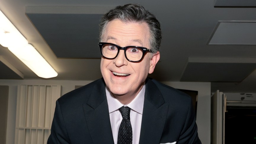 Stephen Colbert smiling and attending an event