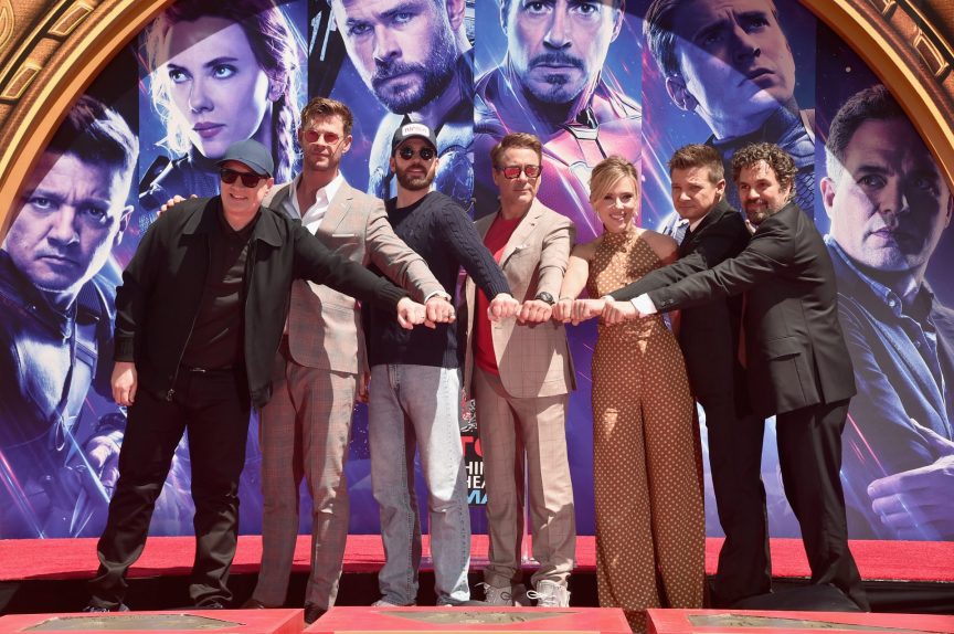 Cast of "Avengers: Engame" putting their hands together.