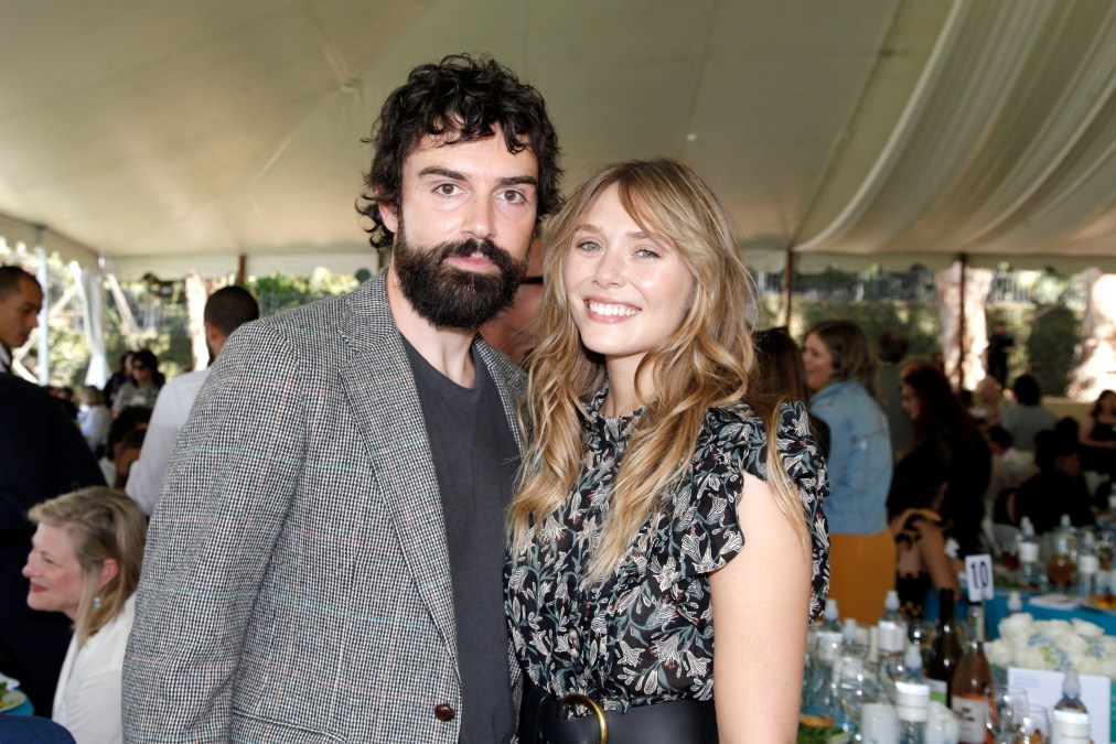 Robbie Arnett and Elizabeth Olsen attend an event