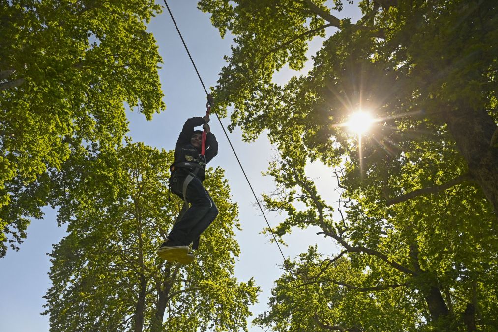 boy riding a zip line