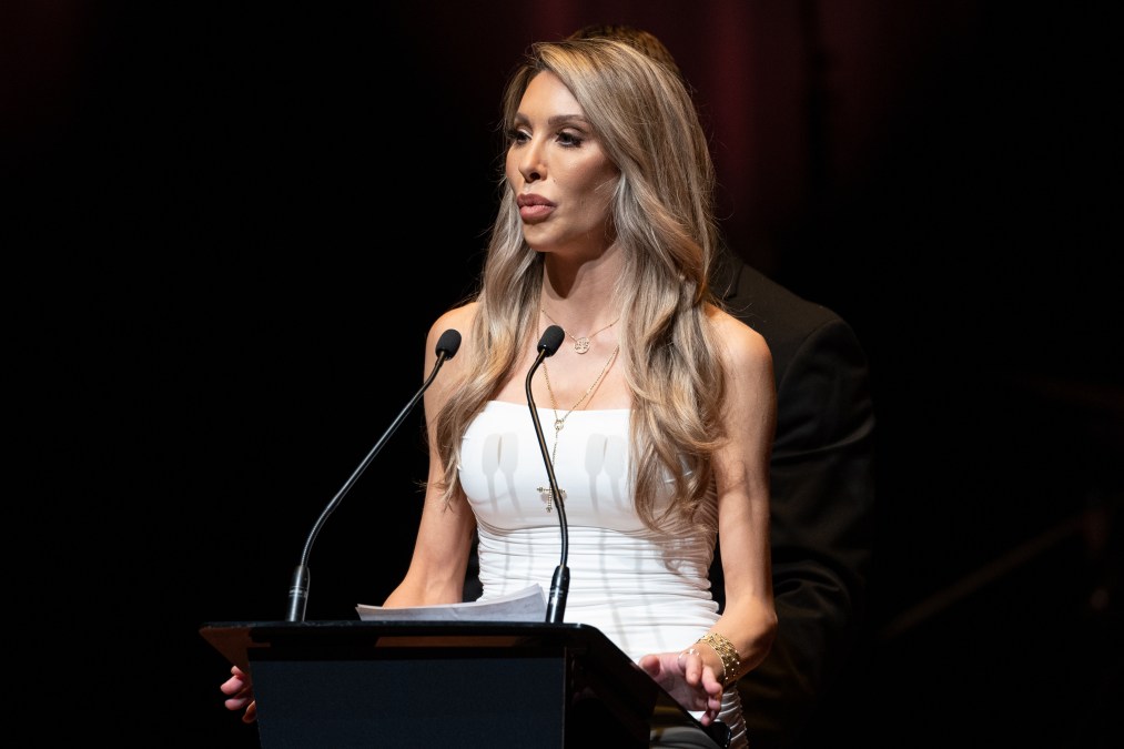 Chloe Lattanzi speaking onstage at her mother's funeral