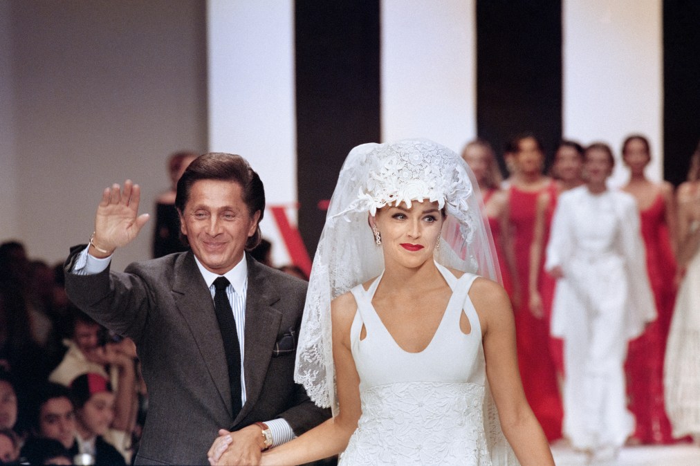 American actress Sharon Stone, wearing a wedding dress and Italian fashion designer Valentino greet the audience at the end of his 1994 Spring/Summer ready to wear collection show