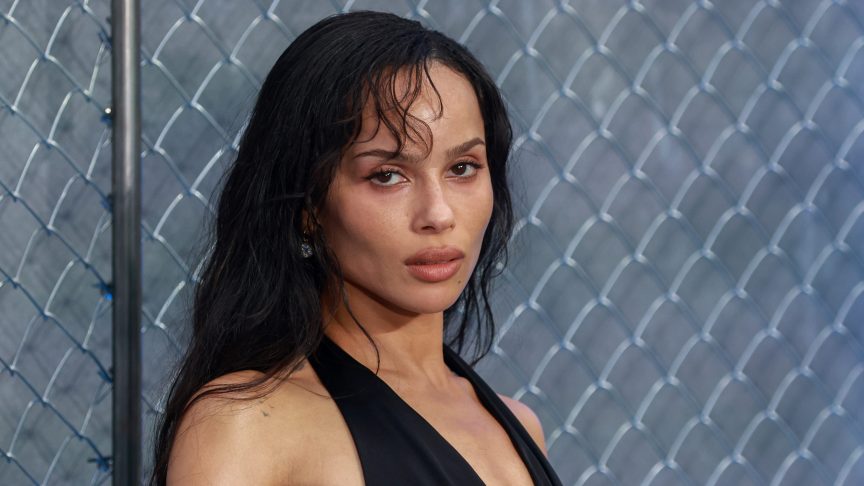 Zoë Kravitz posing on the red carpet at the Caught Stealing UK gala screening in London, wearing an elegant black gown.