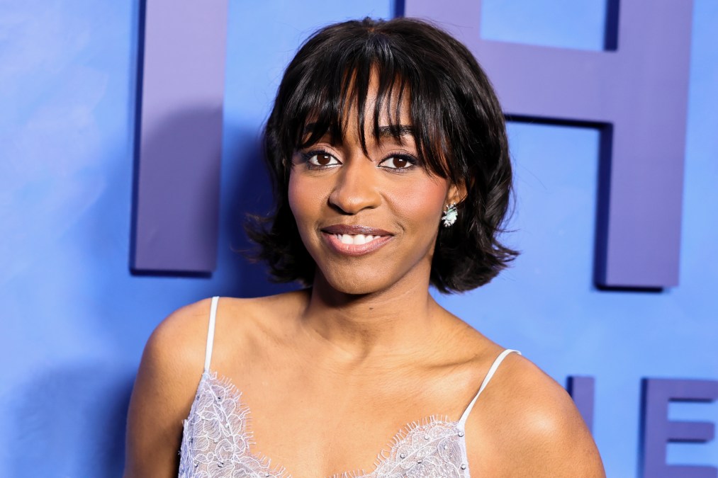 Ayo Edebiri posing for media portraits in front of the blue FX event backdrop at the series celebration.