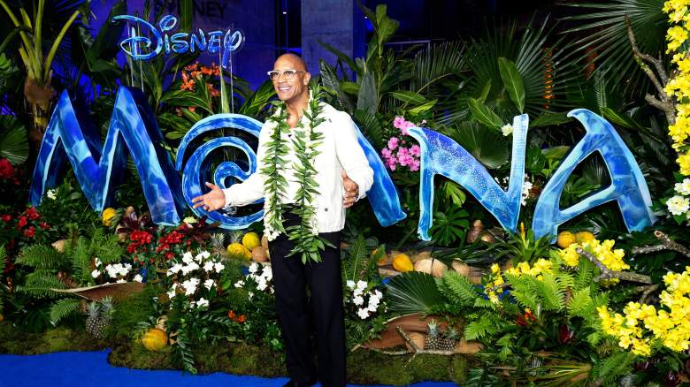 Dwayne Johnson in front of the "Moana" logo.